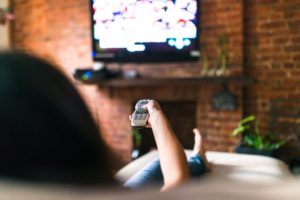 Woman watching TV on couch