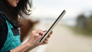 Woman using tablet outside