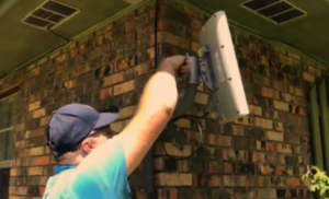 Technician installing fixed wireless antenna