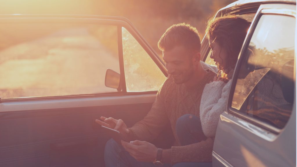 Couple using tablet in car