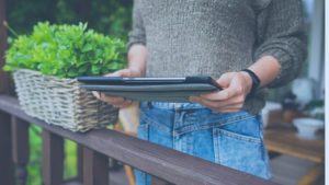 Person using tablet on porch