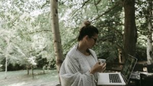 Woman working outside on computer