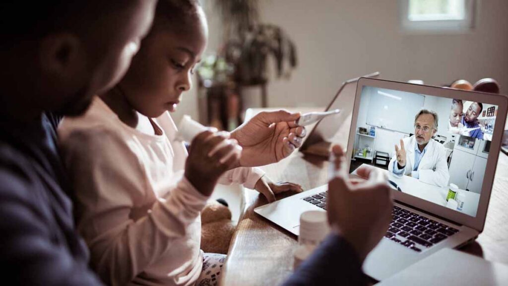 family using laptop to talk to doctor