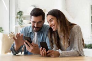 couple-using-phones-together