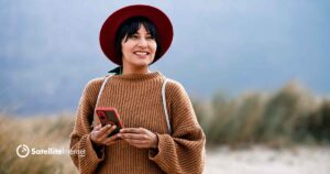 Woman wearing a red hat using phone in a remote location